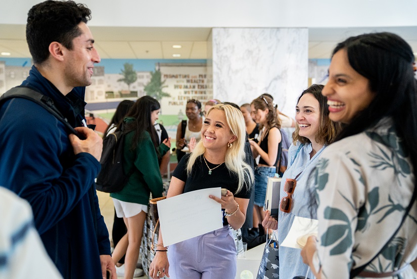 Students share a laugh at an end-of-year gathering in Nesbitt Hall lobby
